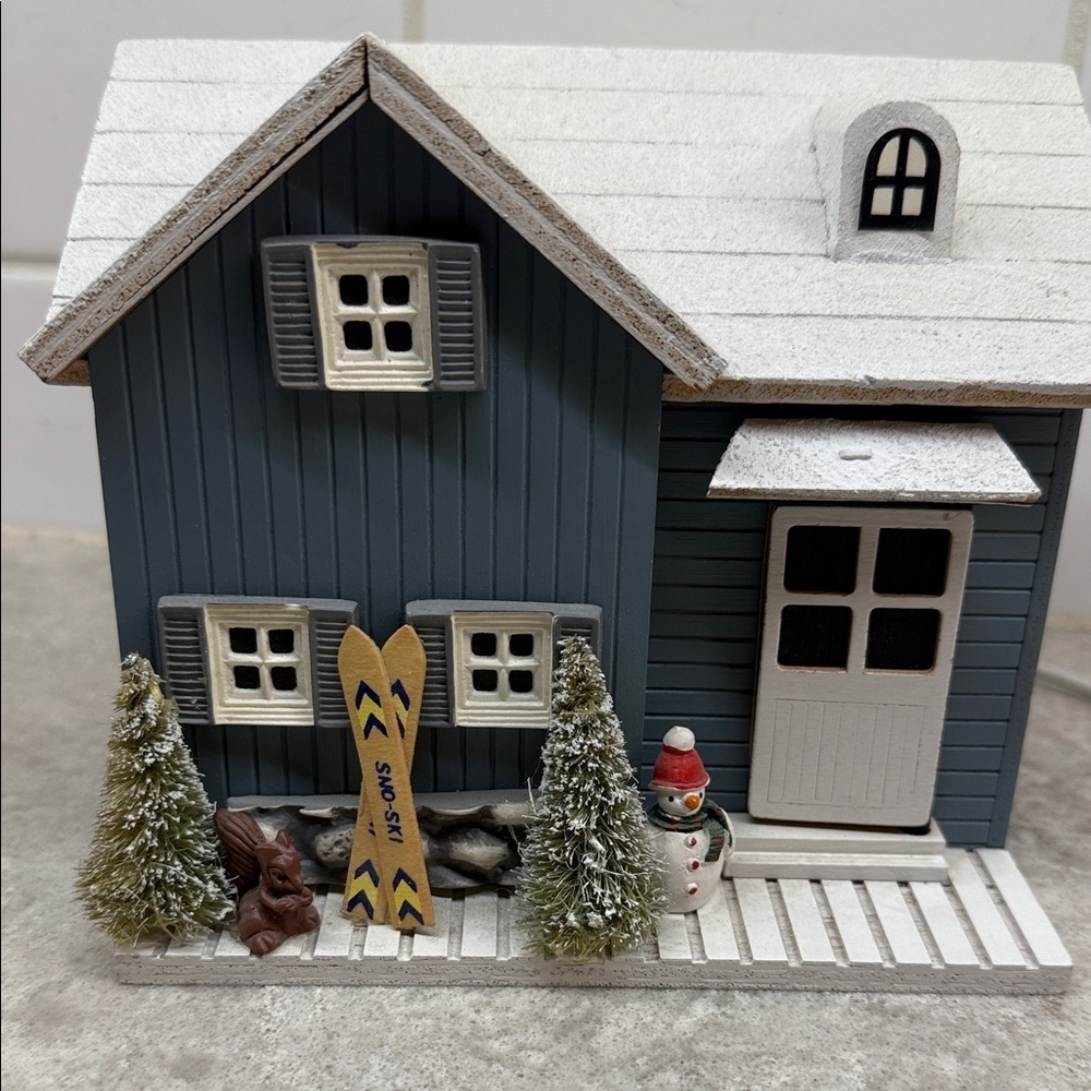 Animated musical ski chalet Winter Wonderland and door opens reveals skier